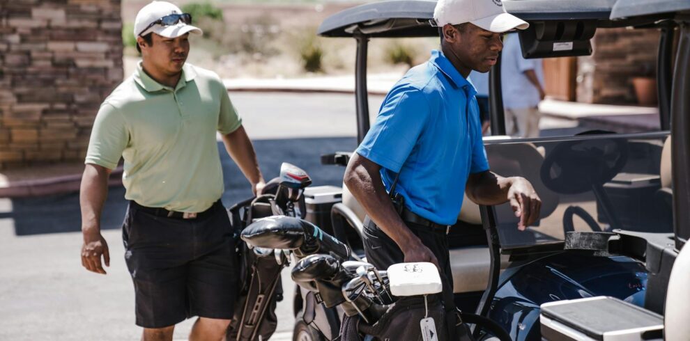 Two Man Standing Beside Golf Carts