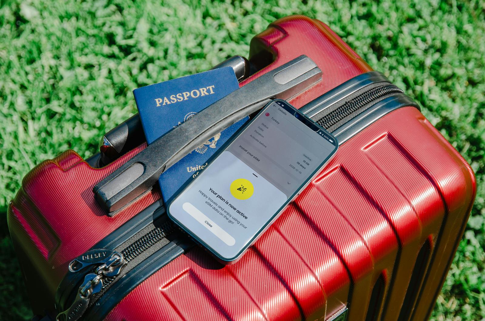 Smartphone and Passport on Suitcase