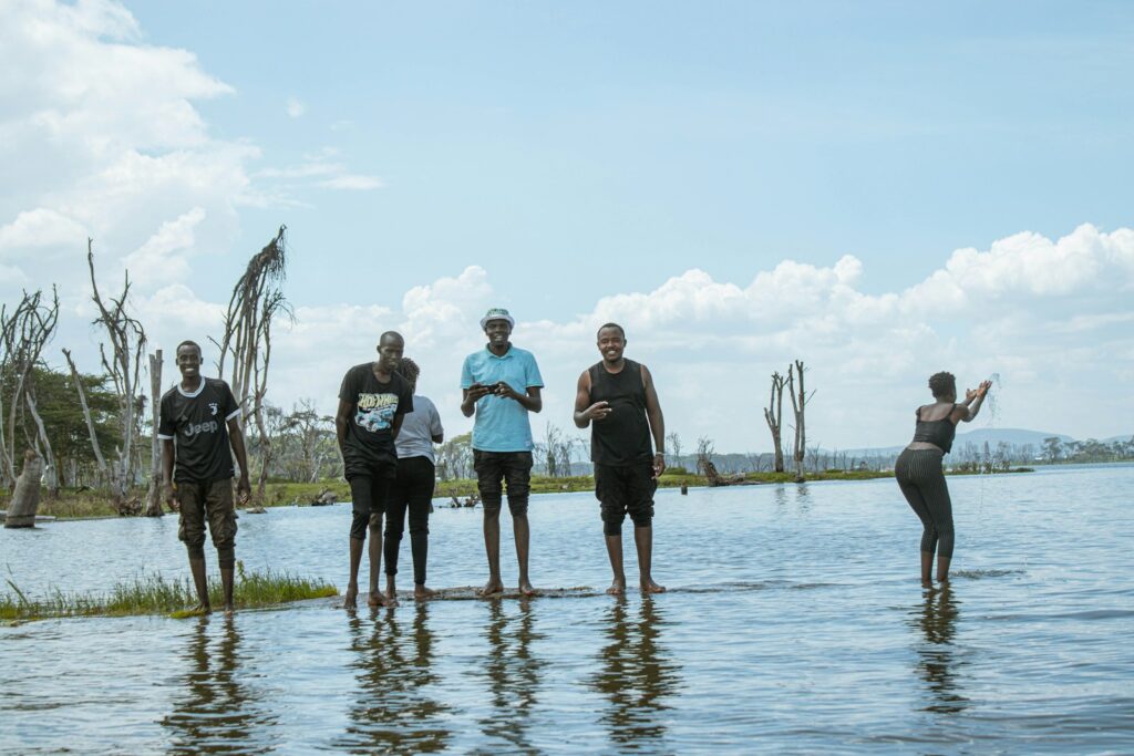 a group of people standing on top of a body of water