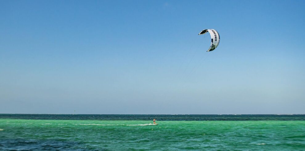 person on body of water kitesurfing