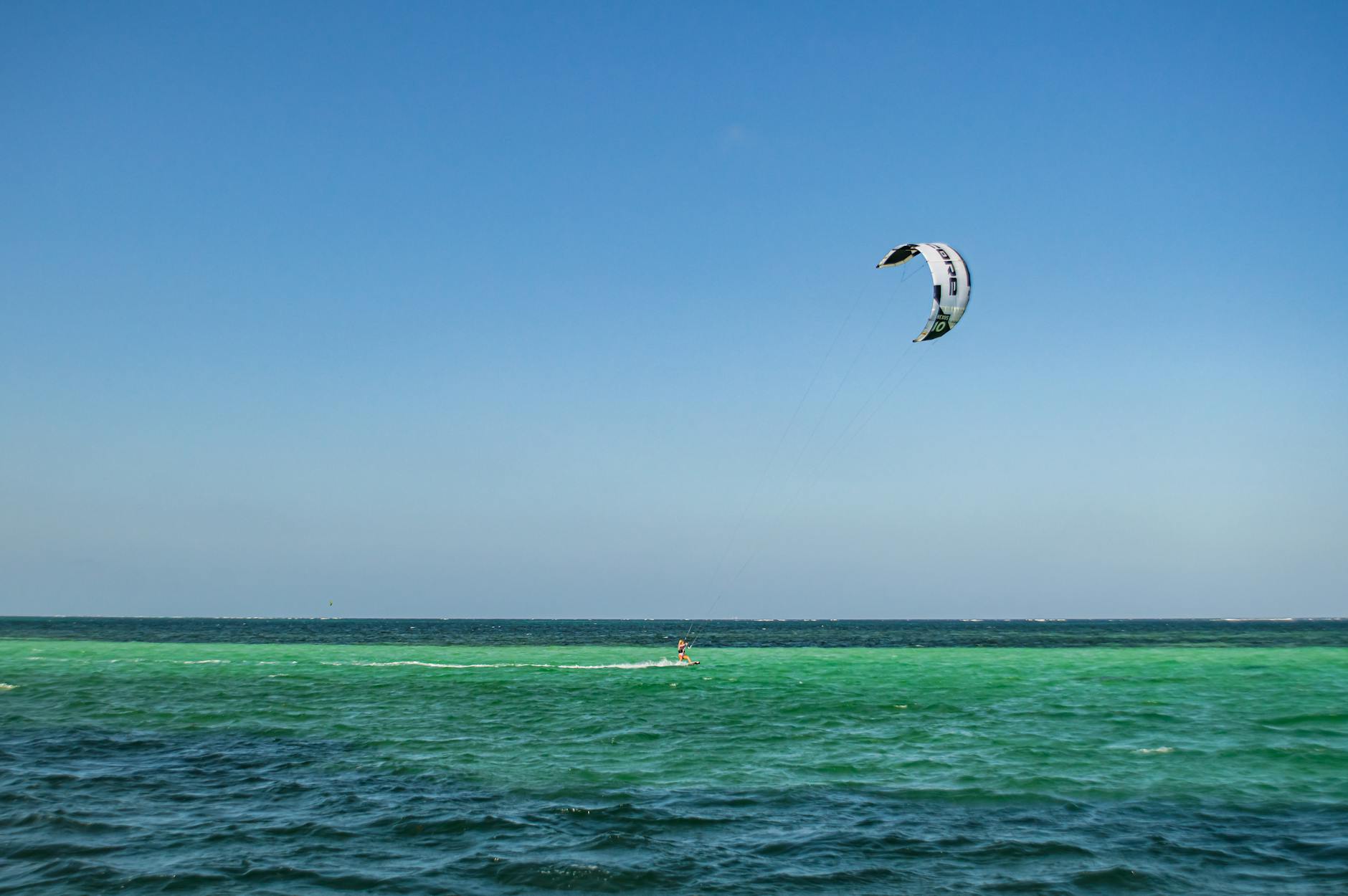 person on body of water kitesurfing